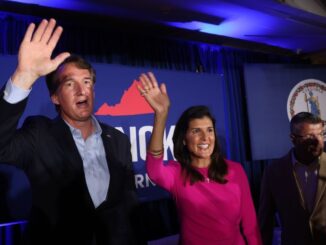 Republican gubernatorial candidate Glenn Youngkin, left, waves to supporters while campaigning with former South Carolina Gov. Nikki Haley in McLean, Virginia, on July 14. Youngkin is running against former Virginia Gov. Terry McAuliffe. (Win McNamee/Getty Images)