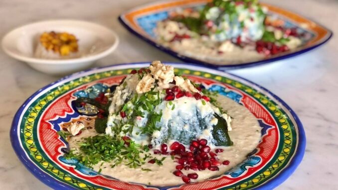 The dish has the colors of the Mexican flag: green, for the peppers and parsley; white for the nogada; and red for the pomegranate seeds sprinkled on top. (Julio Guzmán/Zenger)