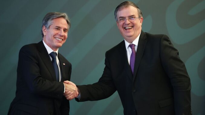 U.S. Secretary of State Antony Blinken (left) and Mexican Foreign Minister Marcelo Ebrard (right) shake hands during a conference as part of the High-Level Security Dialogue at SRE Building on October 8, 2021, in Mexico City. (Photo by Hector Vivas/Getty Images)