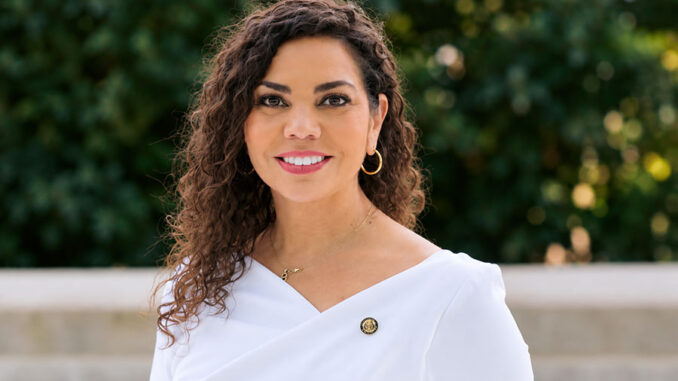 Confident-Woman-in-White-with-Gold-Pin
